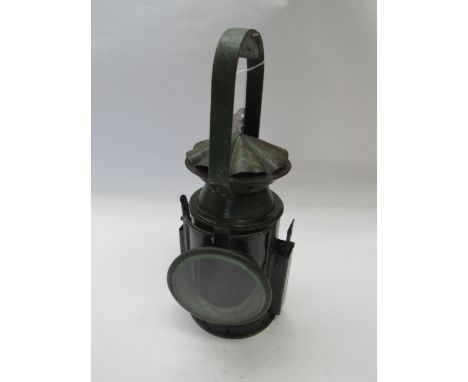 A three aspect army issue hand lamp, reservoir and burner interior, side plaque showing broad arrow and dated 1945
