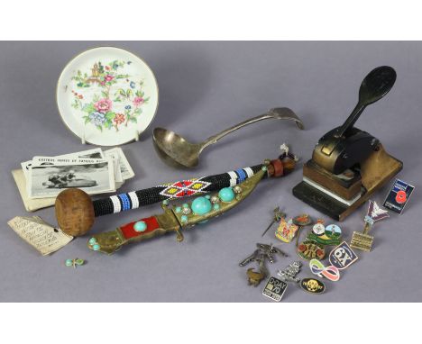 An African beaded wooden ceremonial Knobkerrie, 9½” long; a ceremonial dagger; various enamelled badges, etc.