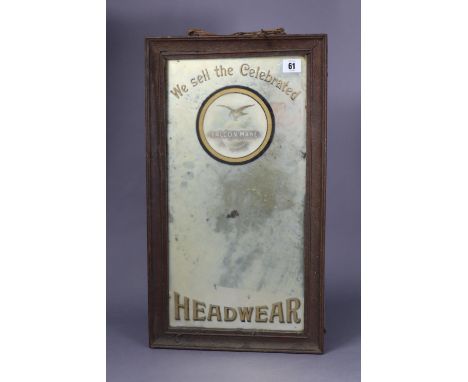 A vintage rectangular wall mirror “We Sell the celebrated Falcon Make Headwear”, 21½” x 12¼”, framed.