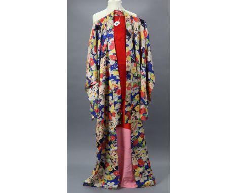 An early-mid 20th century Japanese kimono with all-over floral decoration on a blue ground, with red &amp; pink lining, with 