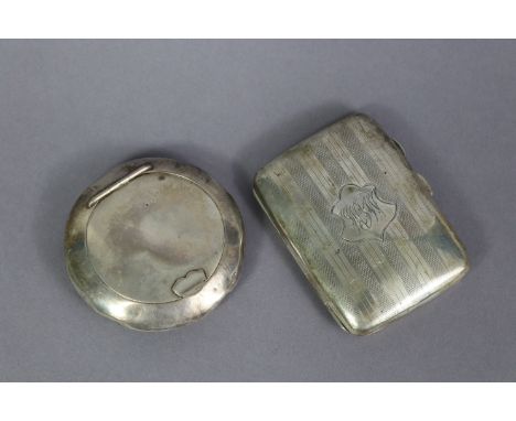 A George V silver compressed round pocket tobacco pouch, with squeeze release to the hinged lid, 2¾” diam., Birmingham 1923; 