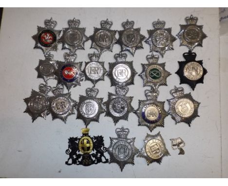 Twenty British steel and plastic police helmet badges all queens crown. Condition Report: Several of the fixing lugs on the r