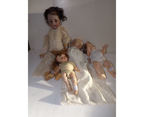 A Simon and Halbig (K&R) porcelain head doll a.f. together with three other dolls.