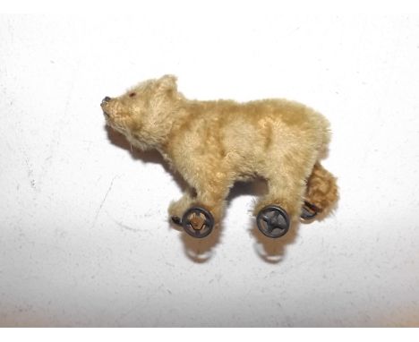 A possible Steiff bear on metal wheels full height 3 1/2"