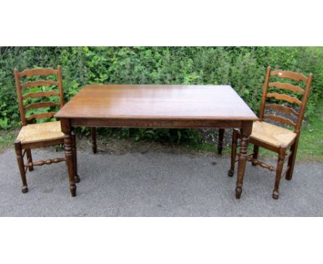 Oak rectangular kitchen table on turned legs and a set of four oak ladder-back chairs with drop in seats 