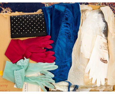 A box containing various textile items including gloves in assorted sizes and colours, a white fur cape, two fur collars, eve