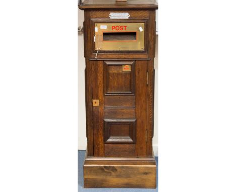 A George V oak private post box, complete with key and post collection times, brass surround to the letter slot