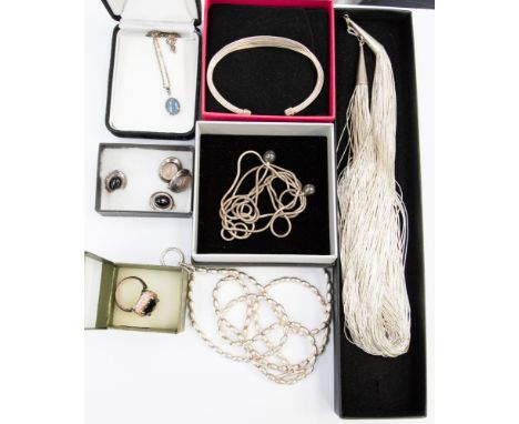 A quantity of eight silver jewellery items, comprising three necklaces, two pairs of earrings, a paste set ring, a black opal