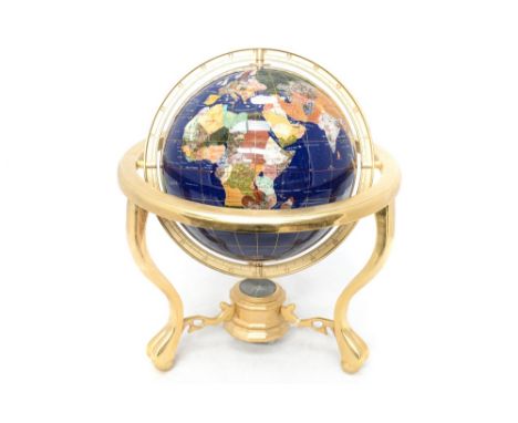 A modern table top globe on a brass stand