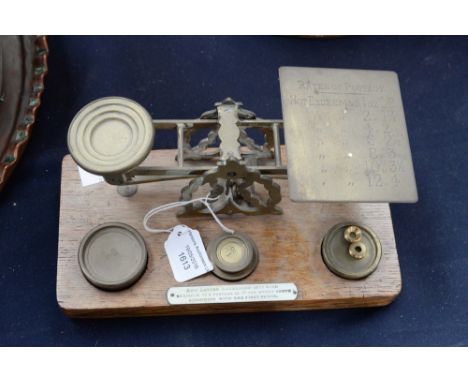 Post Office balance scales in brass on wooden plinth by Mordan & co. London.