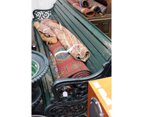 A late Victorian cast iron garden bench, with cast iron ends, one side stamped 'Crane Foundry (W Ton) Ltd', with a wooden sla