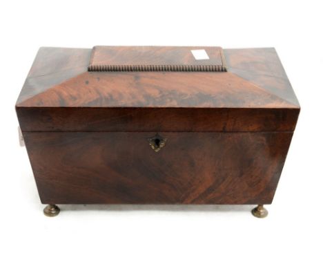 A Regency mahogany tea caddy, circa 1800, sarcophagus form, twin compartment interior with central mixing/sugar bowl on turne