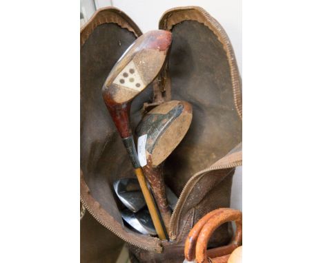 A vintage stovepipe leather golf bag, containing hickory clubs, circa 1920 