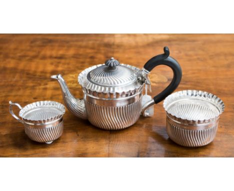 A late Victorian silver spiral semi-fluted Bachelors tea service comprising of teapot, sugar bowl and jug, London 1890, maker