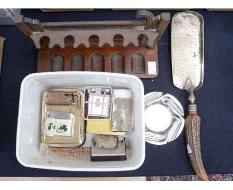 A WTBS five bar gate brass pipe rack, various cigarette lighters, an interesting clay pipe head, Vesta/match holder and ashtr