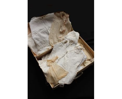 A white vintage case containing various white linens, including late Victorian and Edwardian drawers, bloomers, petticoats, c