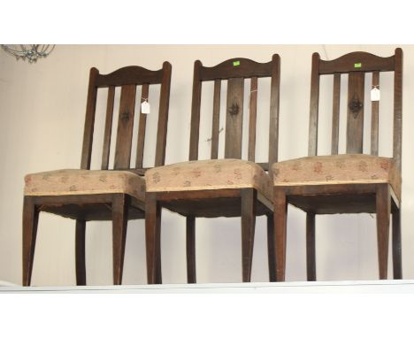 A collection of various chairs, comprising three Arts and Crafts oak chairs, an early Victorian walnut side chair, raised on 
