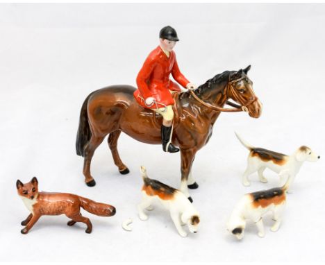 A Beswick huntsman, mounted on horse with blaze and two white lower legs, three hounds and a fox