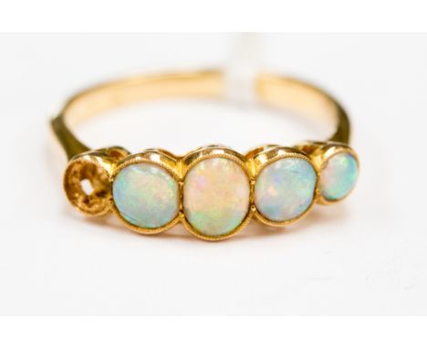 A gold opal five stone ring (one stone missing)