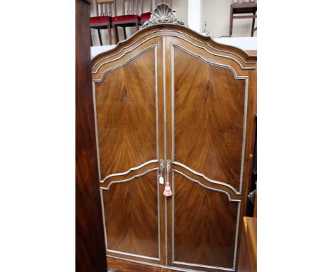 An early 20th Century walnut veneered bedroom suite, comprising double wardrobe, chest of drawers, dressing table, bedside ca