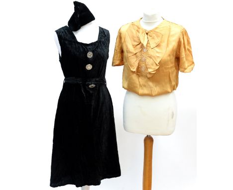 One gold satin blouse, 1930s, with a frilled jabot and bow with glass buttons, together with a late 1930s velvet dress in bla