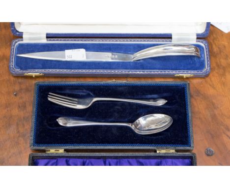 An Elizabeth II silver boxed paper knife, marked Birmingham 1970, together with a silver Christening spoon and fork, gross si
