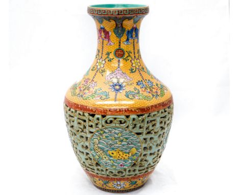 Chinese yellow reticulated vase, bearing Quanlong six character seal mark, the body pierced with roundels of fish, shoulders 