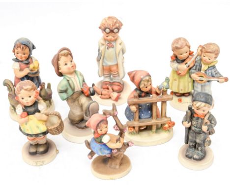 A collection of eight Hummel and Goebel figures