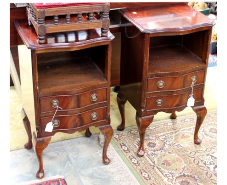 A pair of mahogany bedside cabinets, fitted with an open shelf section and two drawers below, raised on cabriole legs (2)