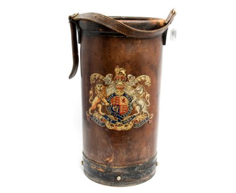 A leather powder flask with Kings Crown Coat of Arms, currently being used as a stick stand