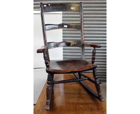 A 19th Century Elm seated beech rocking chair of ladder back form