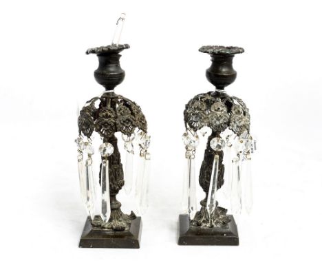 A pair of Victorian bronze lustres, single sconce candle sticks  with cast foliate decoration 