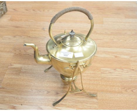 An Art Nouveau brass kettle on stand complete with an oil burner to base