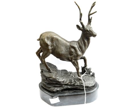 A cast bronze red deer mounted on marble plinth 