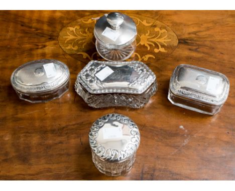 Five glass silver topped dressing table jars, three with engine turning and two with cut glass bodies(5)