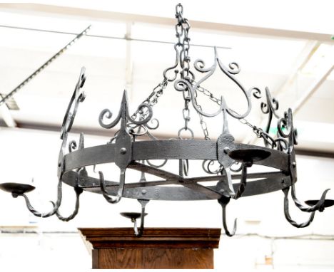 A wrought iron hanging candle holder centre light fitting