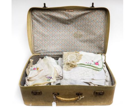 A suit case full of vintage tablecloths embroidered lace and napkins, tray cloth etc, large quantity 