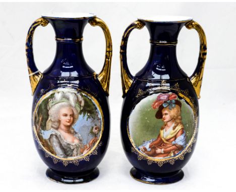 A pair of Staffordshire twin handled vases, late 19th early 20th Century both with gilding on cobalt ground and with transfer