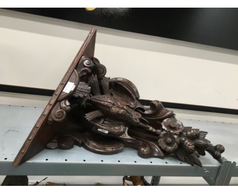 A large carved oak corner shelf decorated with dead game birds and flowerheads (54cm).