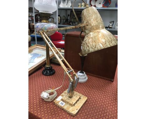An early 20th century Herbert Terry angle poise light in painted marble effect.