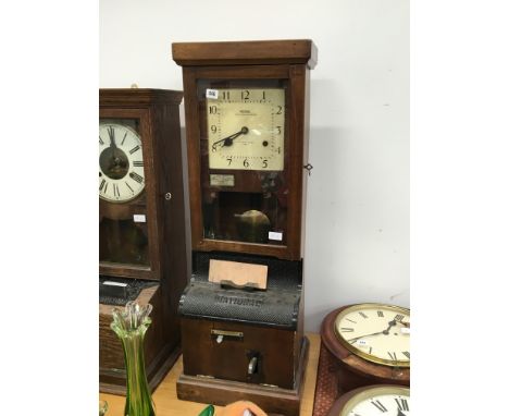 An early 20th century oak cased National Time Recorder clocking in clock.