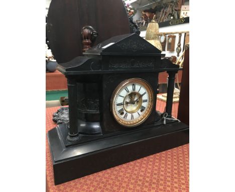 A large late 19th century slate cased architectural mantle clock with white ceramic dial  and American movement.