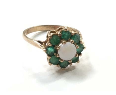 A 9 carat gold opal and emerald set ring.