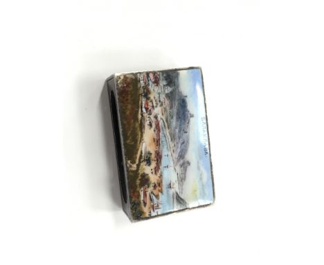 A Russian silver and enamel matchbox case, decorated with a Russian resort scene.