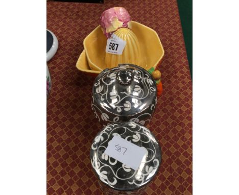 A Carlton ware lemon squeezer decorated in orange together with a similar napkin ring and two Gray's honey jars.