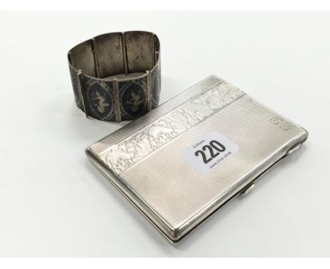 An engine turned silver cigarette case with engraved trailing leaf decoration to front and reverse (169g) and an Eastern silv