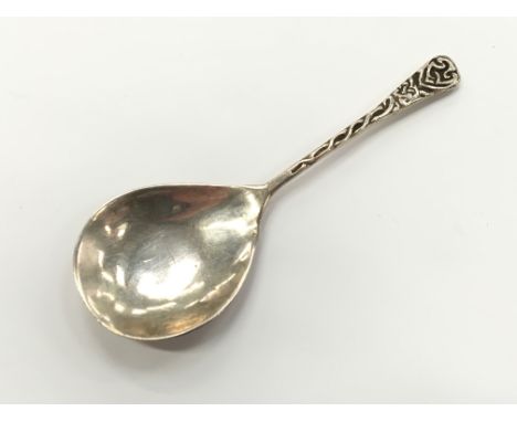 An Arts and Crafts silver caddy spoon with Celtic style decoration to stem probably by Sydney and Co.