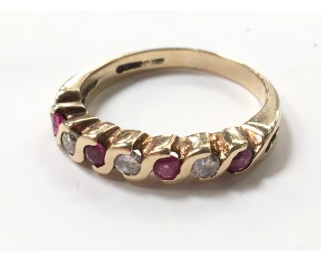 A 9 carat gold ruby and diamond eternity ring.