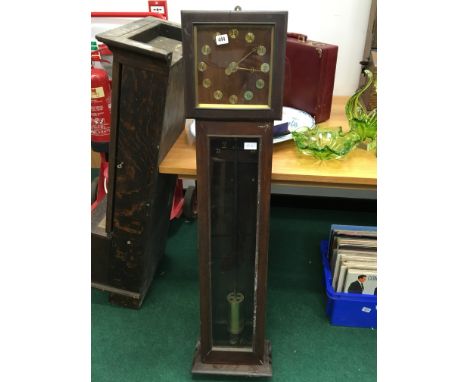 A longcase mahogany framed wall clock with visible heavy brass Magento pendulum.