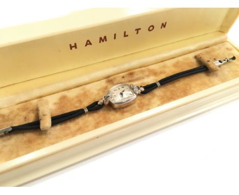 A ladies 14k white gold and diamond set Hamilton manual wind wristwatch in the original Hamilton cream coloured plastic case.